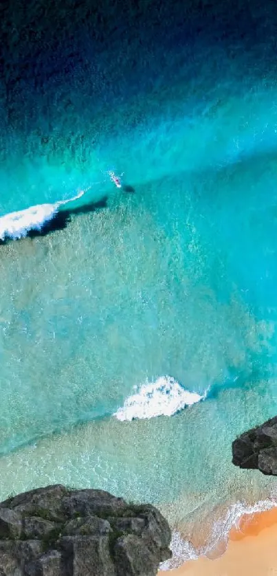 Serene beach with teal waters and gentle ocean waves.