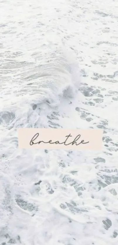 Calming ocean waves with word 'breathe' on a mobile wallpaper.