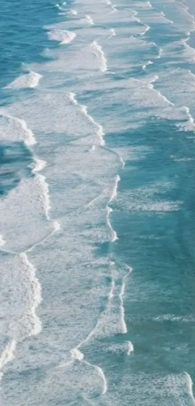 Aerial view of serene blue ocean waves rolling onto the shore.