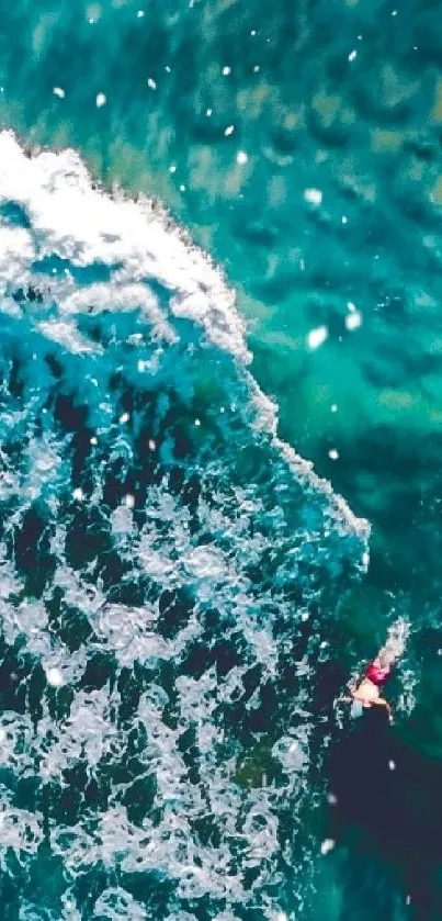 Aerial view of turquoise ocean waves crashing dynamically.