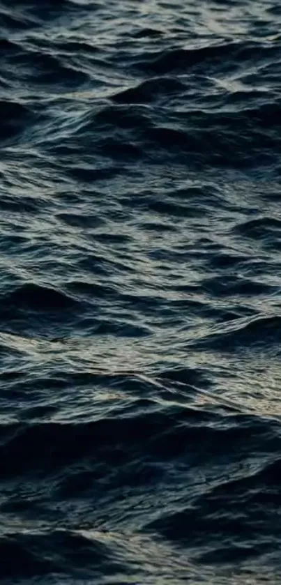 Dark blue ocean waves creating a serene pattern.