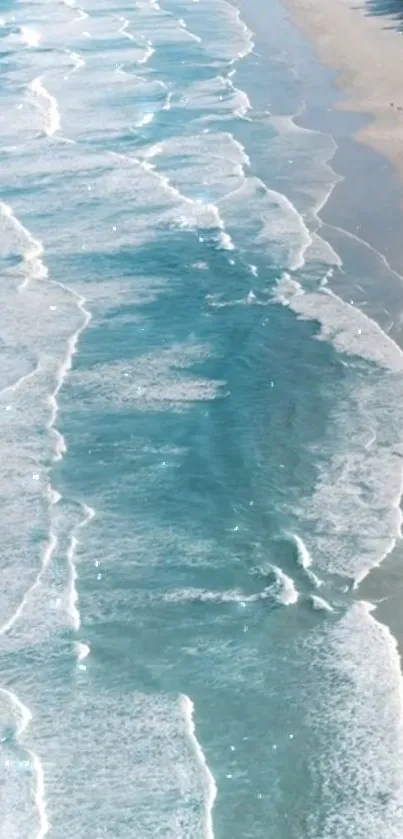 Serene ocean waves with white foam on a sandy beach, perfect for mobile wallpaper.