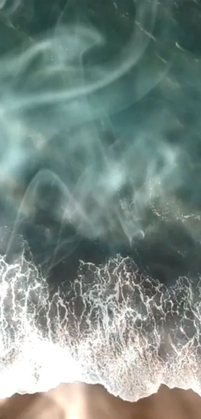 Aerial view of emerald ocean waves crashing on the beach.