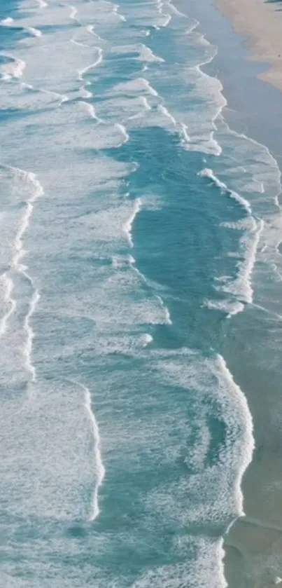 A calming ocean waves wallpaper with white foam and sandy beach.