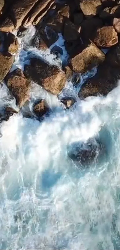 Aerial view of ocean waves crashing against rocky shoreline.