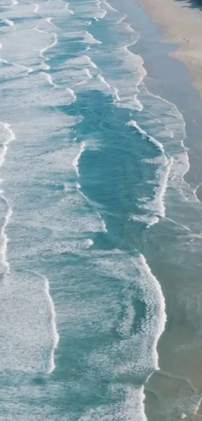 Aerial view of ocean waves on a sandy beach, creating a calming atmosphere.