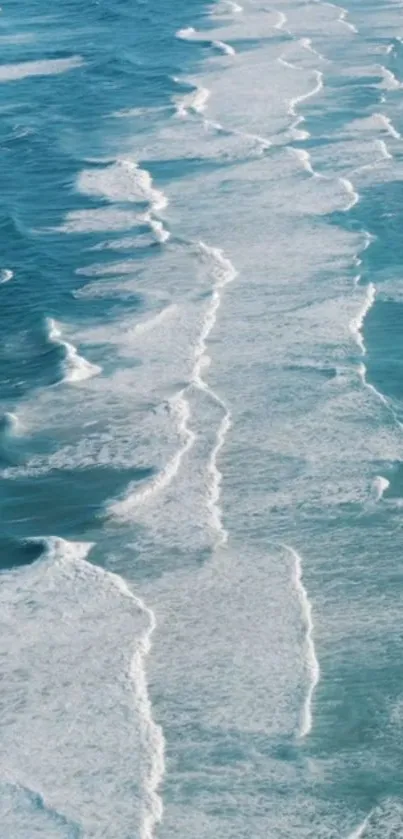 Aerial view of serene ocean waves and blue water in a calming phone wallpaper.