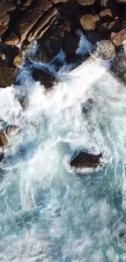 Aerial view of ocean waves crashing onto rocky shore.