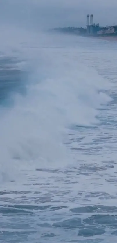 Serene ocean waves crash onto a beach with a distant coastal view.