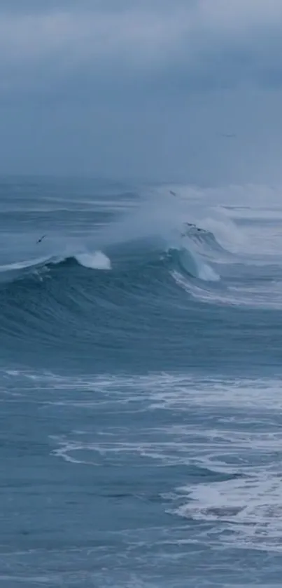 Serene ocean waves with mist in blue tones.