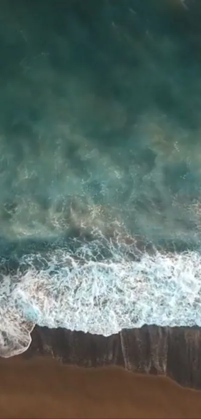 A soothing aerial view of ocean waves hitting the beach.