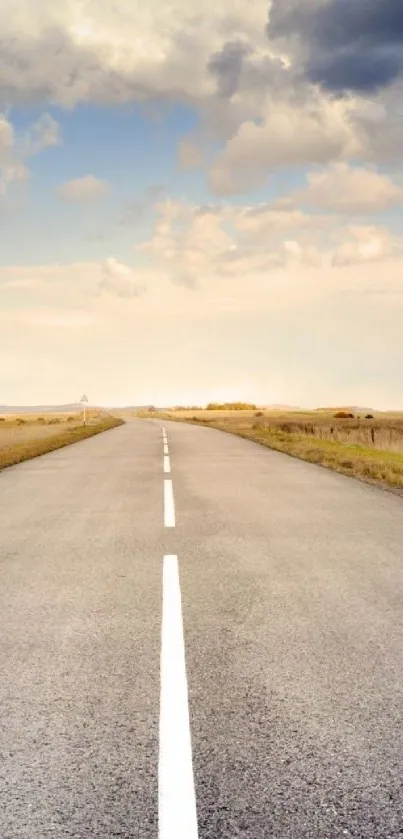 Open road leading into a tranquil sky with golden fields on either side.