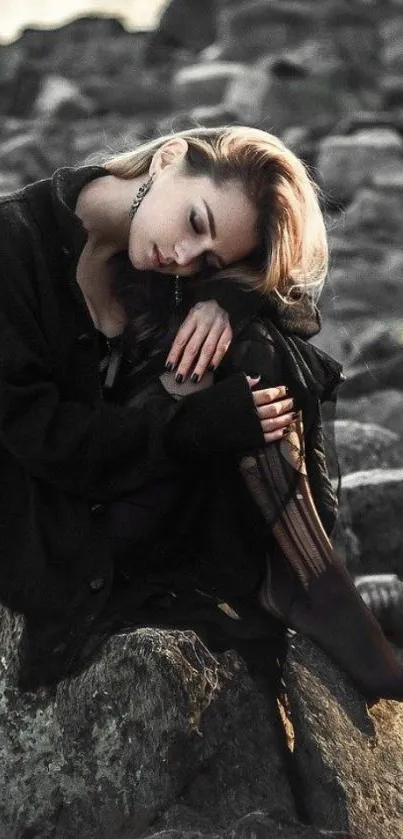 Woman sitting on rocks in a serene outdoor setting, by the water.