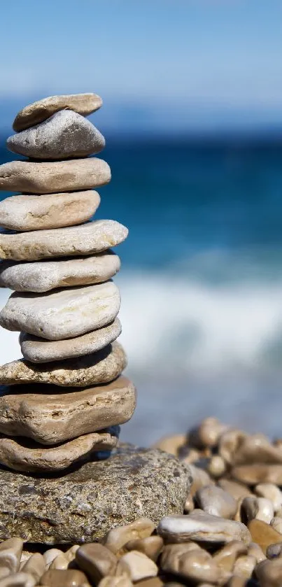 Stack of pebbles on a beach with ocean waves in the background.