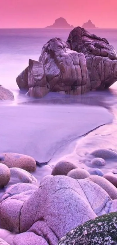 Pink sunset over rocky beach, tranquil ocean scene.