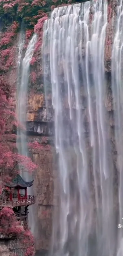 Serene waterfall with pink foliage and a pagoda, ideal for a calming phone wallpaper.