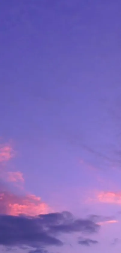 Tranquil purple sky with fluffy clouds.