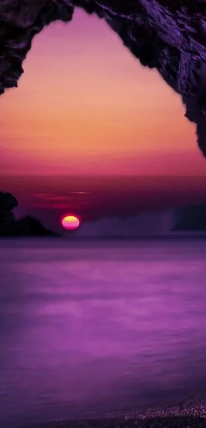 Purple sunset over ocean seen from a rocky cave opening.