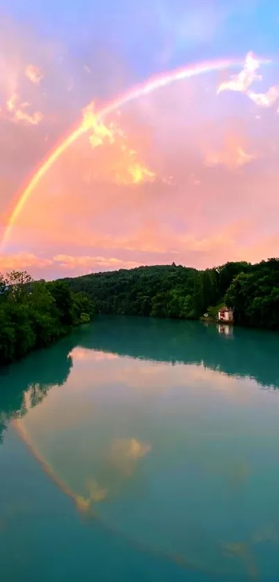 Vibrant rainbow over tranquil lake with lush greenery and sunrise sky.