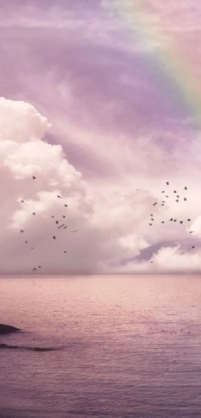 Lavender ocean view with a rainbow and clouds.