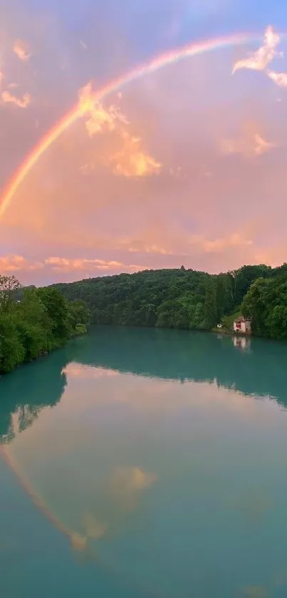 Serene river with a rainbow in the sky reflecting on the calm water.