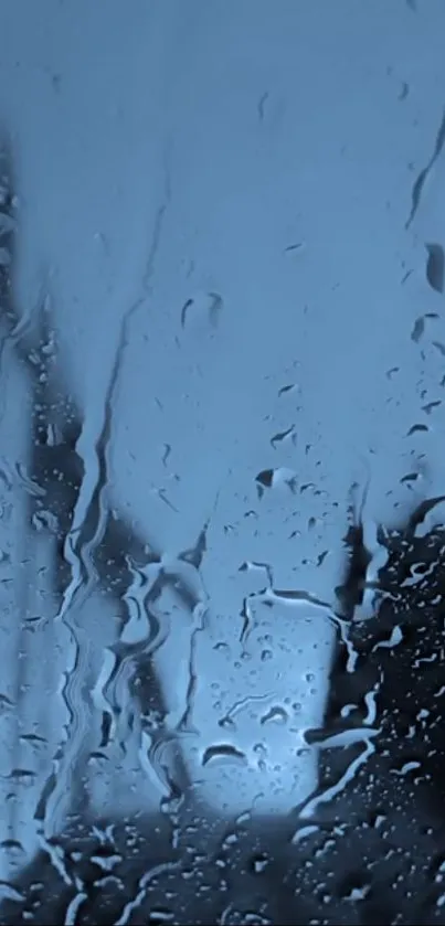 Raindrops on a window with a calming blue background.