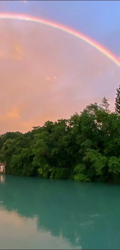 Serene river with lush greenery and a vibrant rainbow in the sky.