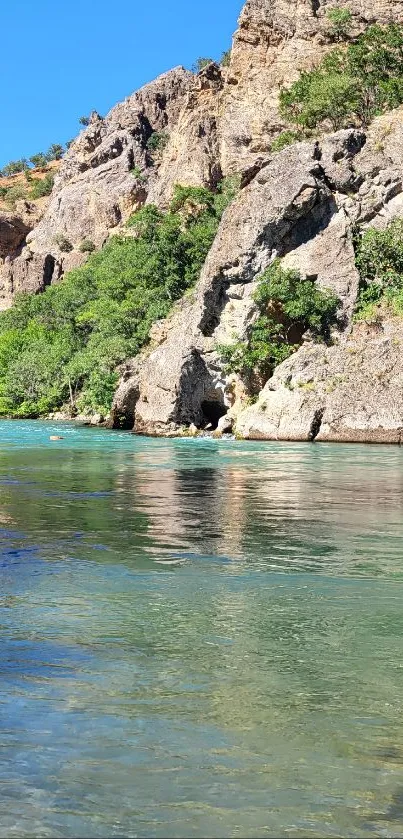 Serene river flows by a rocky landscape.