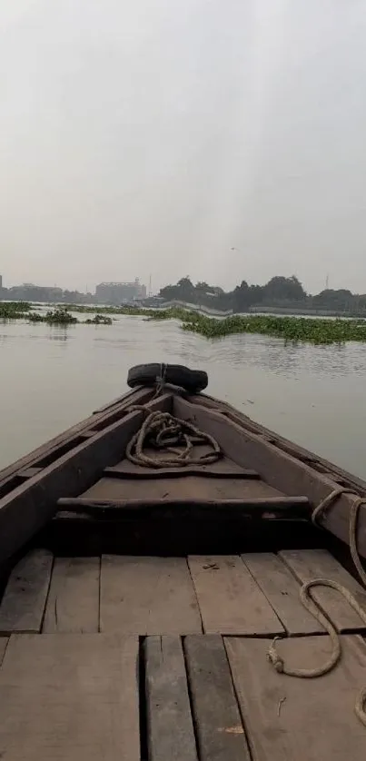 Wooden boat on a serene river with a tranquil view.