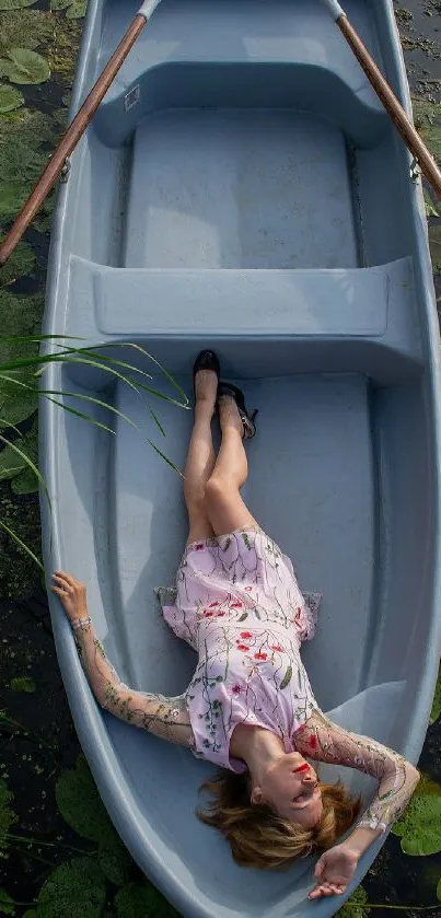 Woman in floral dress relaxing in a boat surrounded by water-lilies.