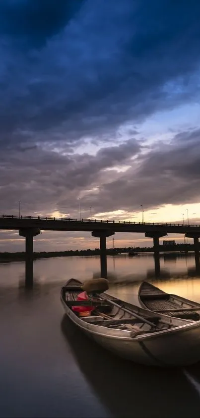 Calm river with moored boats at sunset under a vibrant evening sky.