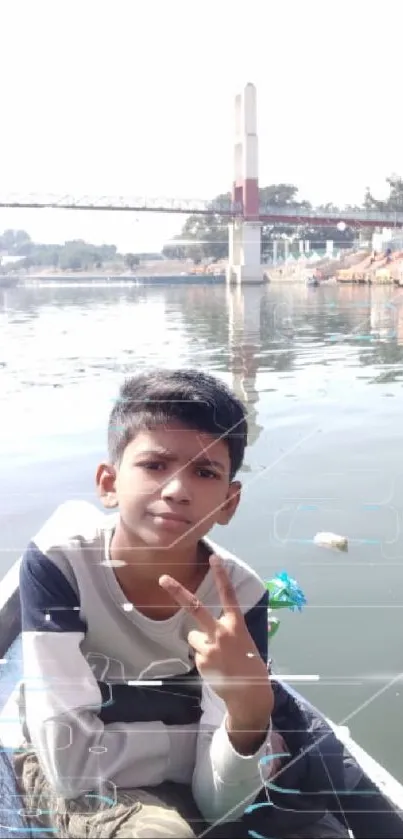 Boy on a boat with peace sign, river and bridge background.