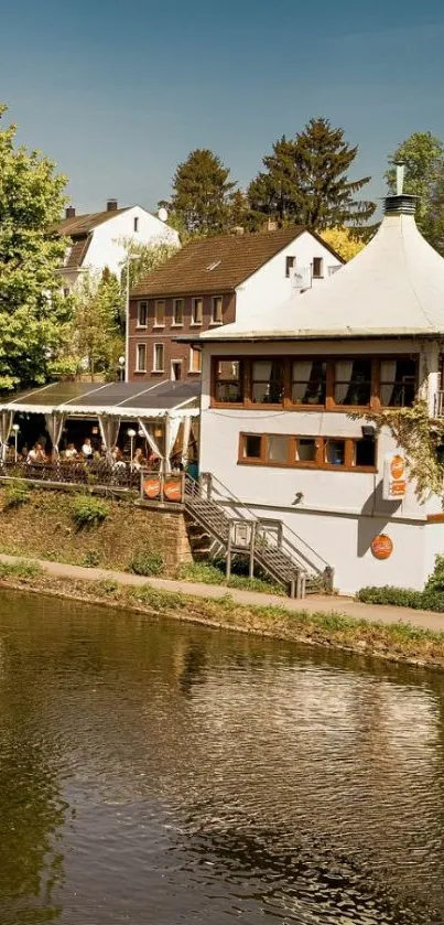 Scenic riverside house under a clear blue sky.