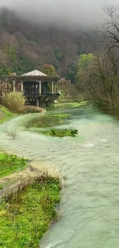 Tranquil river scene with lush greenery and a rustic building.