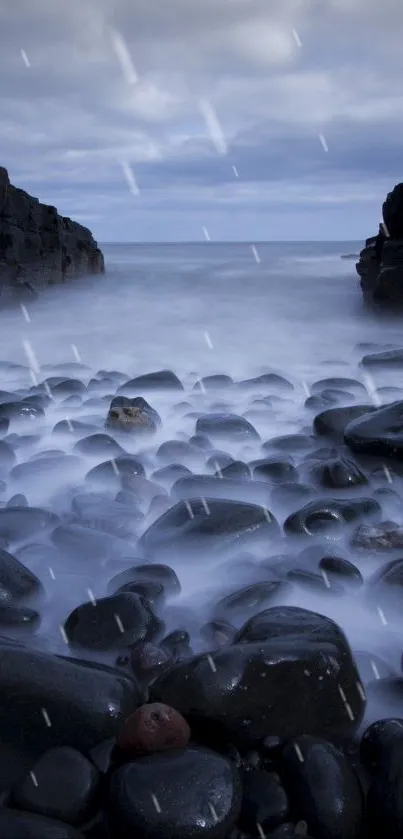 Misty rocky coast under cloudy sky with soft raindrops.