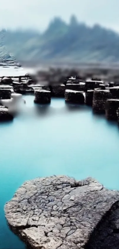 Serene rocky lake with light blue water and blurred distant hills.