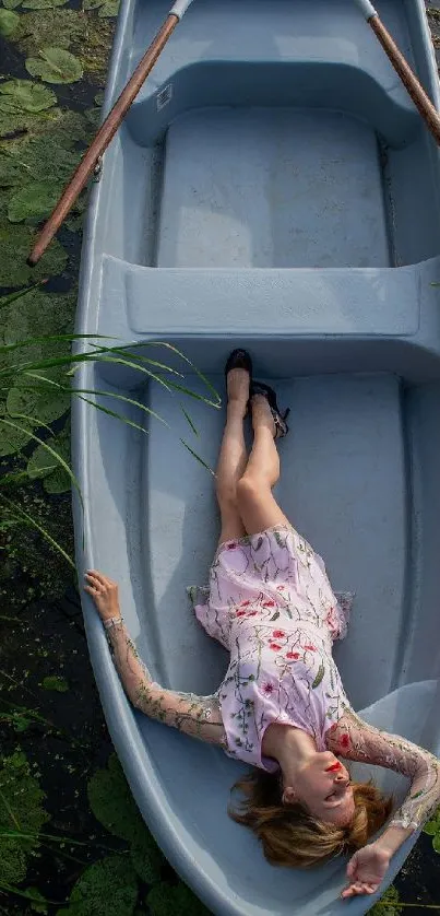 Woman in floral dress relaxing in a rowboat with water lilies.