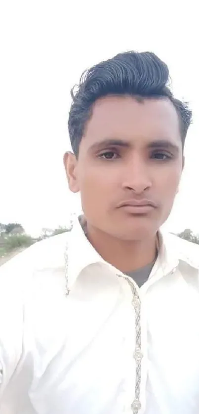 Portrait of a person on a rural road with a serene natural backdrop.