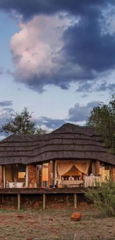 Safari lodge in the wilderness under a cloudy blue sky.