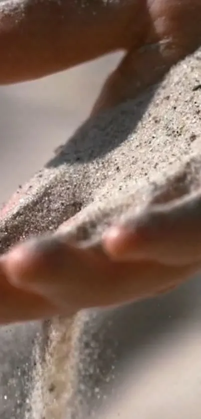 Sand gently flowing through a hand, creating a calming scene.