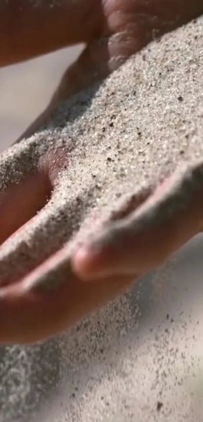 Close-up of sand gently flowing through a hand, creating a serene and peaceful vibe.