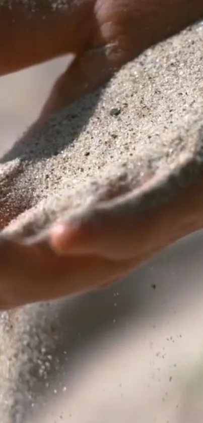Close-up of sand flowing through gentle hands.