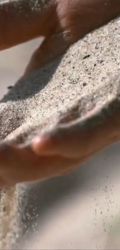 Close-up of sand flowing gently through hands.