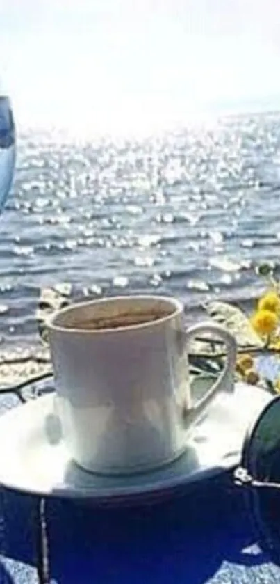 Coffee cup by the sparkling sea with sunglasses and a glass, perfect for relaxation.