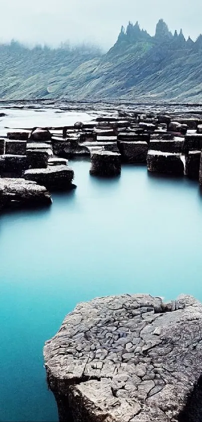 Serene seascape with uniquely shaped rocks in bluish tones.