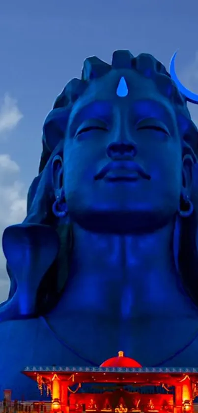 Majestic Shiva statue set against a vibrant blue sky, creating a serene atmosphere.