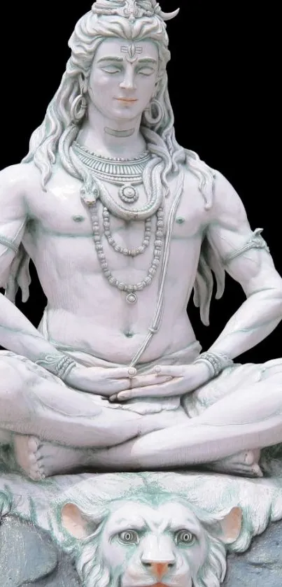 Serene white statue of Lord Shiva meditating in lotus position on a decorative base.