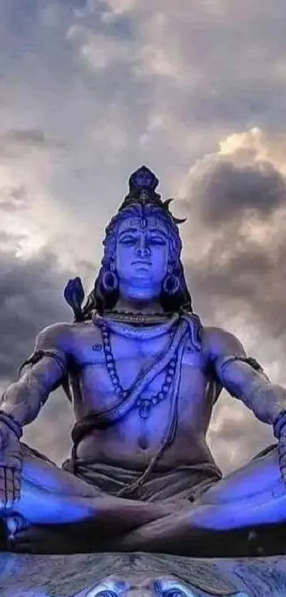 Lord Shiva in meditation under dramatic cloudy sky wallpaper.