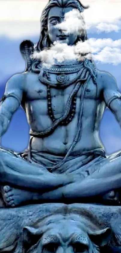 Shiva statue in meditation with a serene blue sky backdrop.