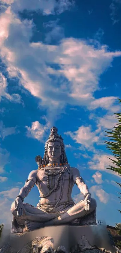 Shiva statue under a vibrant blue sky, capturing spiritual tranquility.